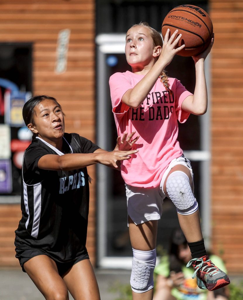We Fired The Dads and the Alphas compete in the 12-13 year old female bracket during the Everett 3on3 tournament in downtown Everett, Washington on Sunday, July 14, 2024. (Annie Barker / The Herald)