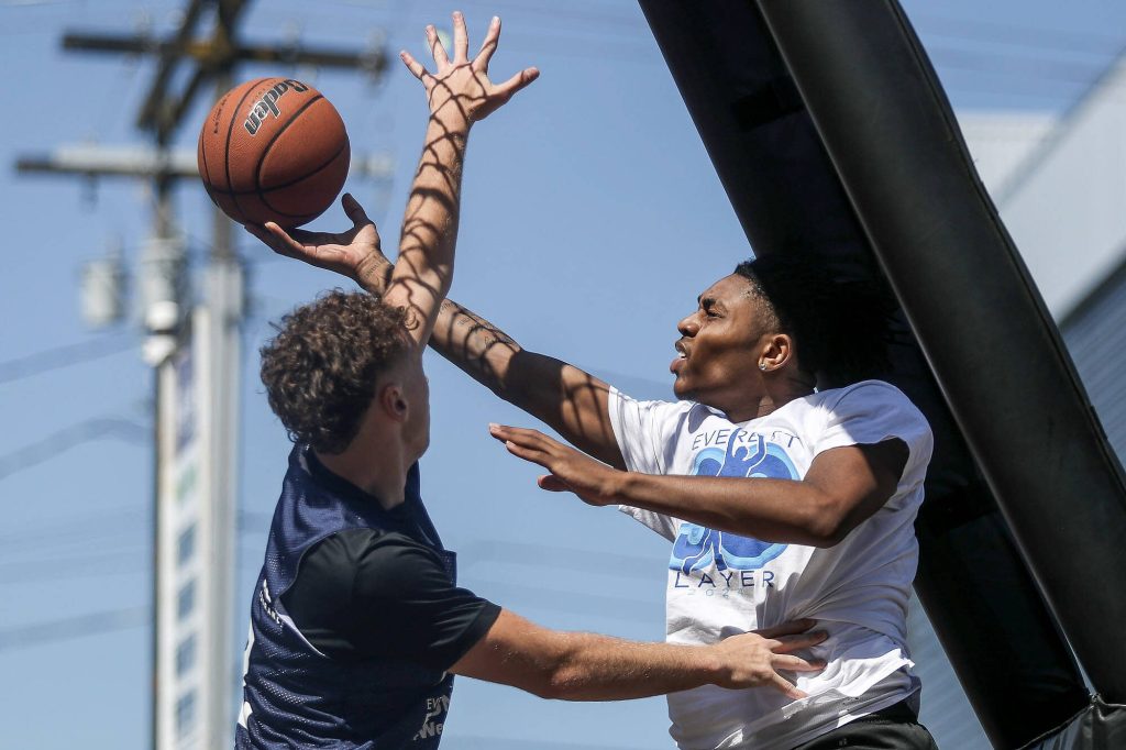 FAB and WeAreEverett face off in the 18 and older mens bracket during the Everett 3on3 tournament in downtown Everett, Washington on Sunday, July 14, 2024. (Annie Barker / The Herald)