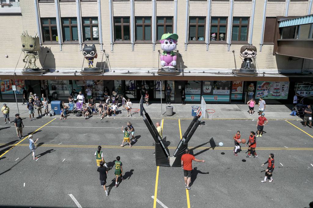 Players warm up and play games during the Everett 3on3 tournament in downtown Everett, Washington on Sunday, July 14, 2024. (Annie Barker / The Herald)