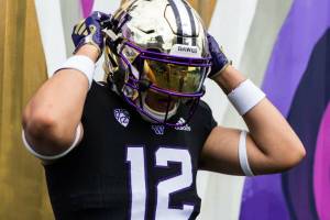 Kamiak High Schools Victor Sanchez Hernandez Jr. puts on a University of Washington football helmet. Sanchez Hernandez, a three-star defensive end whos heading into his senior season, committed to the Huskies. (Photo courtesy of Victory Sanchez Hernandez Jr.)