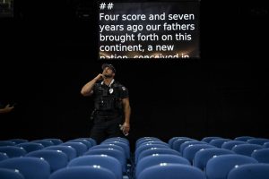 A law enforcement officer surveys the Fiserv Forum in Milwaukee, the site of the Republican National Convention, on July 14, 2024. (Haiyun Jiang/The New York Times)