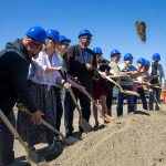 Port officials and future tenants shovel some earth while participating in a groundbreaking ceremony for Restaurant Row at the Port of Everett on Tuesday, July 23, 2024, in Everett, Washington. (Ryan Berry / The Herald)