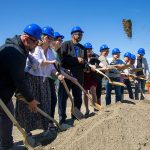 Port officials and future tenants shovel some earth while participating in a groundbreaking ceremony for Restaurant Row at the Port of Everett on Tuesday, July 23, 2024, in Everett, Washington. (Ryan Berry / The Herald)