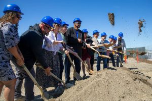 Port officials and future tenants shovel some earth while participating in a groundbreaking ceremony for Restaurant Row at the Port of Everett on Tuesday, July 23, 2024, in Everett, Washington. (Ryan Berry / The Herald)