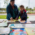 Samantha Grospe helps her son Everett Grospe, 4, pick a book during Lake Stevens Education Foundation Dolly Parton Imagination Library celebration in 2018 in Lake Stevens.