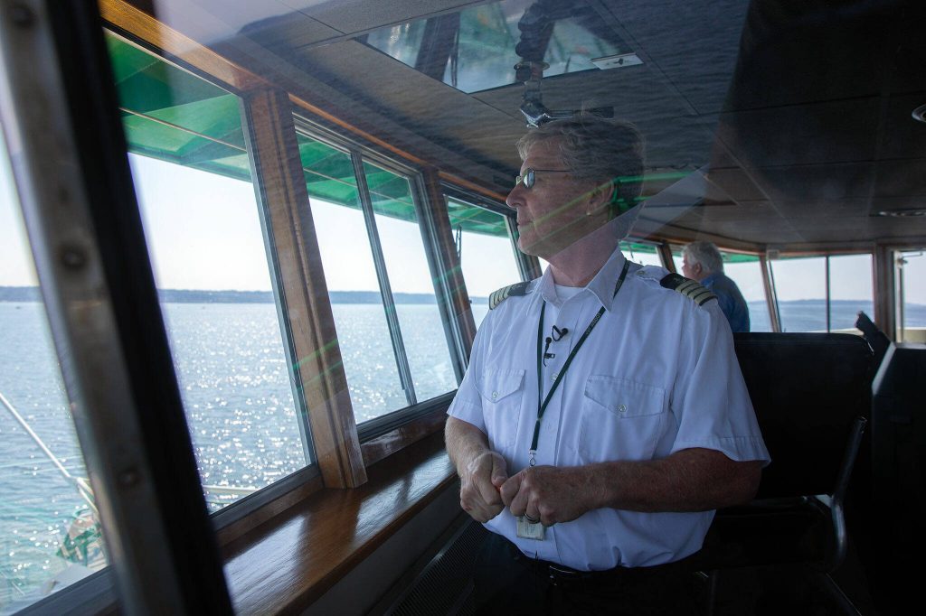 Captain Russell Fee scans the waters ahead of the MV Spokane as the ferry navigates the sound on the Edmonds/Kingston ferry route Thursday, July 18, 2024, near Edmonds, Washington. (Ryan Berry / The Herald)