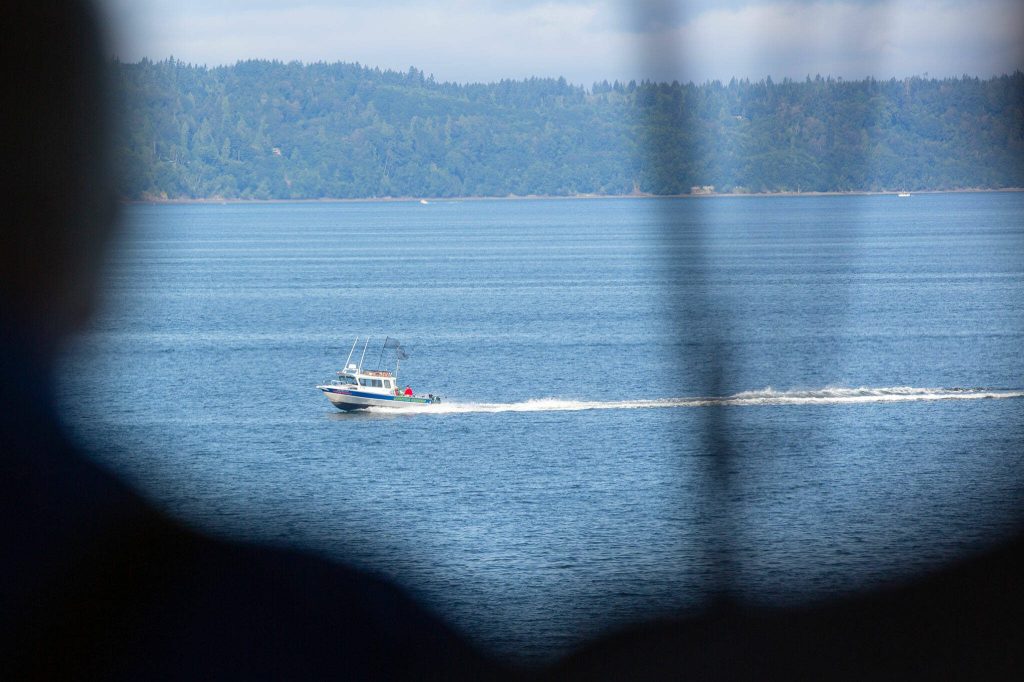 A fishing vessel zooms in front of the MV Spokane as the ferry approaches traffic on Thursday, July 18, 2024, near Kingston, Washington. (Ryan Berry / The Herald)