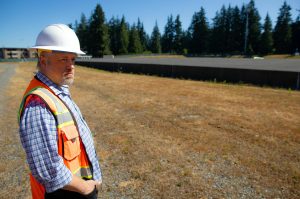 Public Works Senior Engineer Randy Loveless looks out over Everetts 101-year-old reservoir at a groundbreaking ceremony for the Reservoir 3 Replacement Project on Tuesday, July 23, 2024, in Everett, Washington. (Ryan Berry / The Herald)