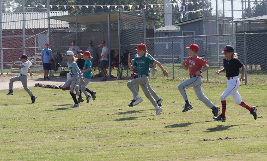 Players for the boys Snohomish Little League 8-10 team warm up before practice at the Snohomish Little League Complex in Snohomish, Washington on Thursday, July 18, 2024. (Taras McCurdie / The Herald)