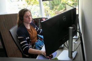 A Volunteers of America Western Washington crisis counselor talks with somebody on the phone Thursday, July 28, 2022, in at the VOA Behavioral Health Crisis Call Center in Everett, Washington. (Ryan Berry / The Herald)