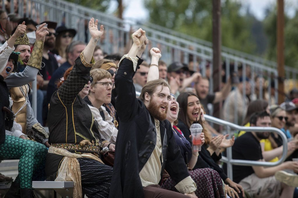 People cheer during the joust at the Washington Midsummer Renaissance Faire near Monroe on Sunday. (Annie Barker / The Herald)