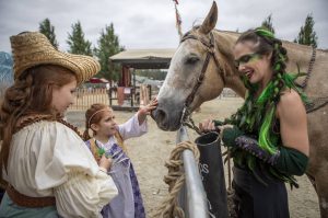 Attendees gather to meet a horse at the Washington Midsummer Renaissance Faire in Snohomish, Washington on Sunday, July 28, 2024.  (Annie Barker / The Herald)