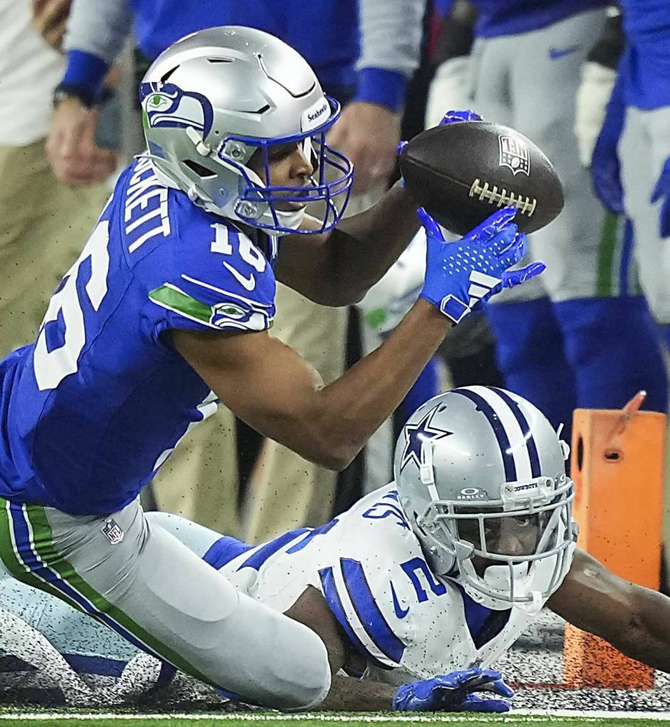 Seattle Seahawks wide receiver Tyler Lockett (16) catches a pass as Dallas Cowboys cornerback Jourdan Lewis (2) defends during the first quarter of an NFL football game on Thursday, Nov. 30, 2023, in Arlington. (Smiley N. Pool / Tribune News Service)