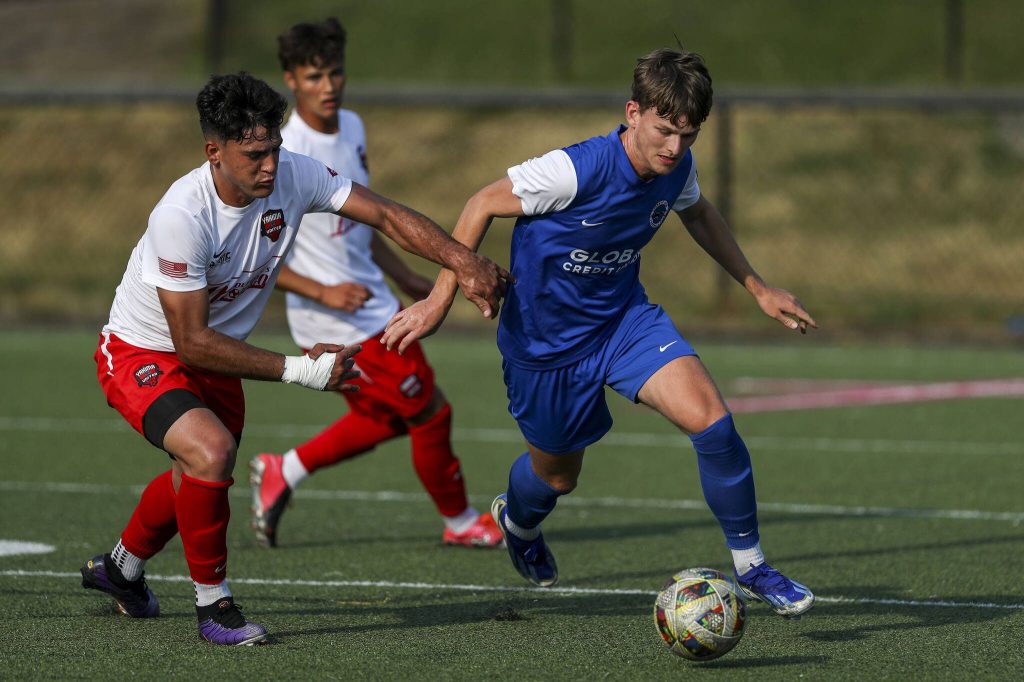Everetts Casey Malcolm (24) fights for the ball during the EPLWA championships between semi-pro mens soccer team Everett Jets FC and Yakima United at Archbishop Murphy High School in Everett, Washington on Saturday, July 27, 2024. Yakima won, 6-1. (Annie Barker / The Herald)