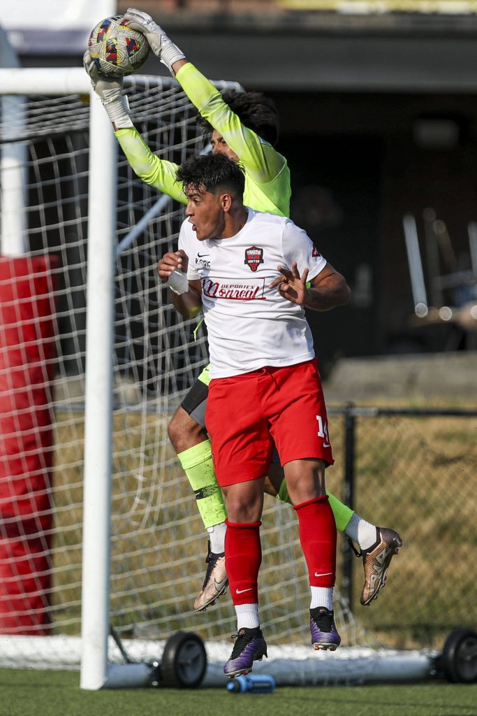 Players fight for the ball during the EPLWA championships between semi-pro mens soccer team Everett Jets FC and Yakima United at Archbishop Murphy High School in Everett, Washington on Saturday, July 27, 2024. Yakima won, 6-1. (Annie Barker / The Herald)