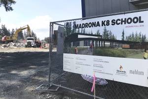 Workers demolish the old building at Madrona K-8 School. Students won't be starting at the new campus. (Stephanie Davey / The Herald)