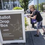 Denise O. turns in ballots at the Snohomish County Campus drop box on Monday, Aug. 5, 2024 in Everett, Washington. (Olivia Vanni / The Herald)