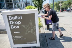 Denise O. turns in ballots at the Snohomish County Campus drop box on Monday, Aug. 5, 2024 in Everett, Washington. (Olivia Vanni / The Herald)