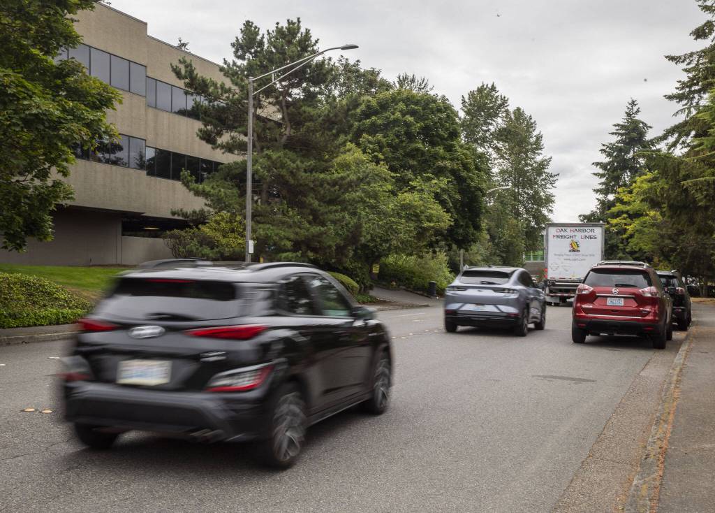 Cars drive along 70th Avenue W past the future site of a stormwater treatment facility on Tuesday, Aug. 13, 2024 in Mountlake Terrace, Washington. (Olivia Vanni / The Herald)