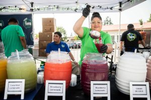 Fabiola Vazquez-Mora of Tacos el Yoyo pours a blackberry lemonade at Taste Edmonds on Friday, Aug. 9, 2024 in Edmonds, Washington. (Olivia Vanni / The Herald)
