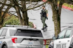 A Sheriffs office walks down a hill toward 112th Street on Wednesday, Jan. 31, 2024 in Everett, Washington. (Olivia Vanni / The Herald)