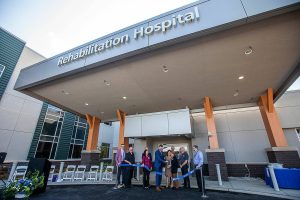 Community members and Providence Swedish employees cut the ribbon for the new Providence Swedish Rehabilitation Hospital on Wednesday, Aug. 14, 2024 in Lynnwood, Washington. (Olivia Vanni / The Herald)