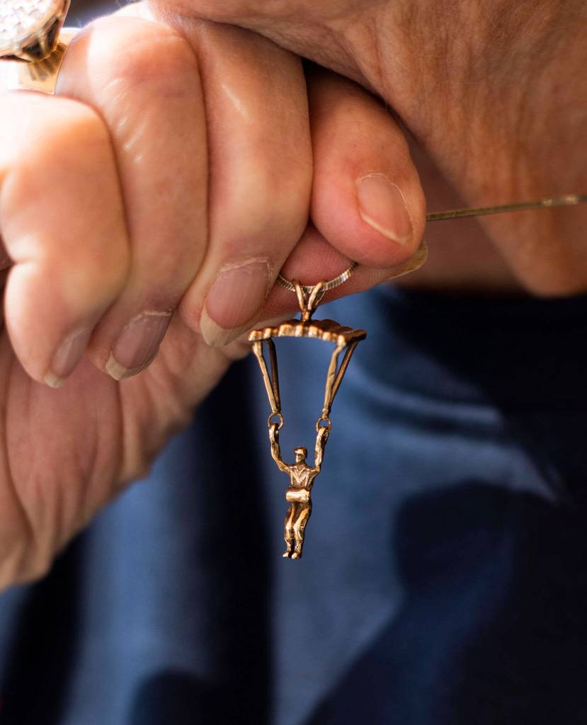 Kim Knor holds up a hold skydiver necklace charm that she wears on Wednesday, Aug. 14, 2024 in Snohomish, Washington. (Olivia Vanni / The Herald)