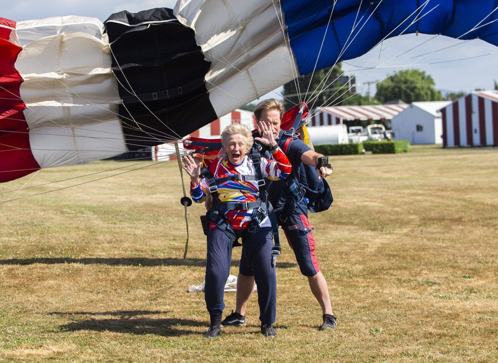 Kim Knor reacts to landing after her 730th skydive on Wednesday, Aug. 14, 2024 in Snohomish, Washington. (Olivia Vanni / The Herald)