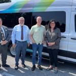 From left to right, Planning & Outreach Manager Bill Windler, Acting Director Craig Cyr, U.S. Rep. Rick Larsen and Vice Chair Jenny Bright stand outside Island Transits electric van. (Selene Muldowney-Stratton / Island Transit)