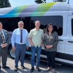 From left to right, Planning & Outreach Manager Bill Windler, Acting Director Craig Cyr, U.S. Rep. Rick Larsen and Vice Chair Jenny Bright stand outside Island Transits electric van. (Selene Muldowney-Stratton / Island Transit)