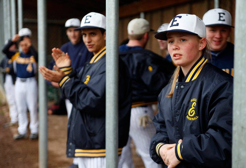 Megan Dedrick, then 14 years old, (right) watches from the dugout during Everetts game against Glacier Peak on Wednesday, March 20, 2013. Dedrick was the second-base starter on Everetts boys baseball team that year. (Genna Martin / The Herald)