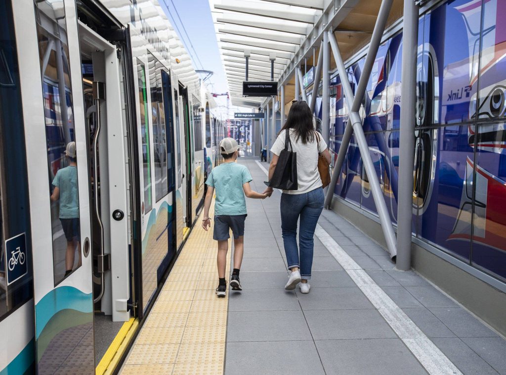 People walk through the Lynnwood City Center station to board the train during the Lynnwood 1 Line extension opening celebrations on Friday, Aug. 30, 2024 in Lynnwood, Washington. (Olivia Vanni / The Herald)