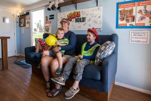 Jill Diner, center, holds her son Sam Diner, 2, while he reacts to the shaking of the Big Shaker, the world’s largest mobile earthquake simulator, with his siblings on Thursday, Aug. 29, 2024 in Marysville, Washington. (Olivia Vanni / The Herald)