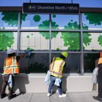 People clean the glass at the Shoreline North station on Wednesday, Aug. 28, 2024 in Shoreline, Washington. (Olivia Vanni / The Herald)