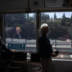 People are illuminated by sunlight as they ride the Link light rail on Wednesday, Aug. 28, 2024 in Mountlake Terrace, Washington. (Olivia Vanni / The Herald)