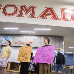 Pierce Butcher, 15, right, a sophomore at Marysville Getchell, holds a sign in silent protest at the Marysville School District budget presentation on Tuesday, Nov. 28, 2023 in Marysville, Washington. (Olivia Vanni / The Herald)