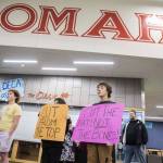 Pierce Butcher, 15, right, a sophomore at Marysville Getchell, holds a sign in silent protest at the Marysville School District budget presentation on Nov. 28, 2023 in Marysville, Washington. (Olivia Vanni / The Herald)