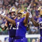 Washington running back Dillon Johnson (#7) waves his arms toward the Oregon crowd after scoring his second rushing touchdown as the No. 3 Huskies face the No. 5 Ducks in the Pac-12 championship game at Allegiant Stadium in Las Vegas on Friday, Dec. 1, 2023.