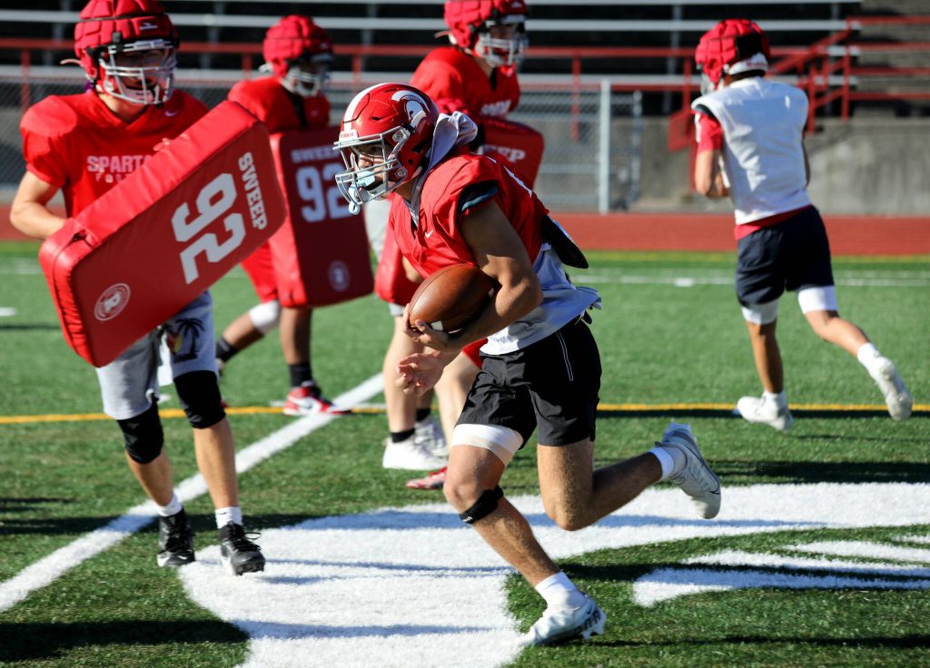 Senior safety and running back Canyon Bumgarner runs during a drill at the Stanwood High School football practice at Bob Larson Stadium in Stanwood, Washington on Aug. 30, 2024. (Taras McCurdie / The Herald)
