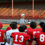 Fourth-year Stanwood High School football coach Jeff Scoma talks with his team at the end of practice at Bob Larson Stadium in Stanwood, Washington on Aug. 30, 2024. (Taras McCurdie / The Herald)