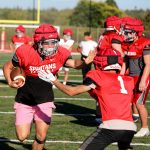 Senior linebacker and running back Cruise Swanson stiff arms a teammate during a drill at the Stanwood High School football practice at Bob Larson Stadium in Stanwood, Washington on Aug. 30, 2024. (Taras McCurdie / The Herald)