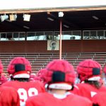 A team photo with the Stanwood High School Spartans logo in the background at Bob Larson Stadium in Stanwood, Washington on Aug. 30, 2024. (Taras McCurdie / The Herald)