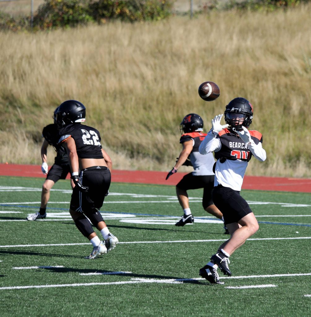 Senior wide receiver and safety Mason Davis prepares to catch the football during a drill at the Monroe High School football practice in Monroe, Washington on Aug. 29, 2024. (Taras McCurdie / The Herald)