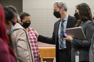 Algeria Canales, the sister of Alisha Canales-McGuire who was murdered by a man hired by Kevin Lewis, becomes emotional while speaking with deputy prosecutor Jarett Goodkin after the jury found Lewis guilty of first degree murder in 2021 in Everett. (Olivia Vanni / The Herald)
