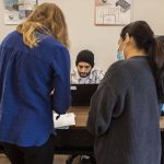 Volunteers help people schedule and check-in for appointments at The Village on Casino Road on Friday, Sept. 20, 2024 in Everett, Washington. (Olivia Vanni / The Herald)
