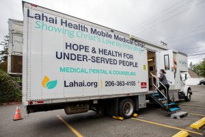 Maggie Konstanski walks onto the Lahai Health Mobile Medical Clinic set up at The Village on Casino Road on Friday, Sept. 20, 2024 in Everett, Washington. (Olivia Vanni / The Herald)