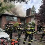 Firefighters on the scene of a triplex fire Tuesday afternoon in Everett. (Everett Fire Department)