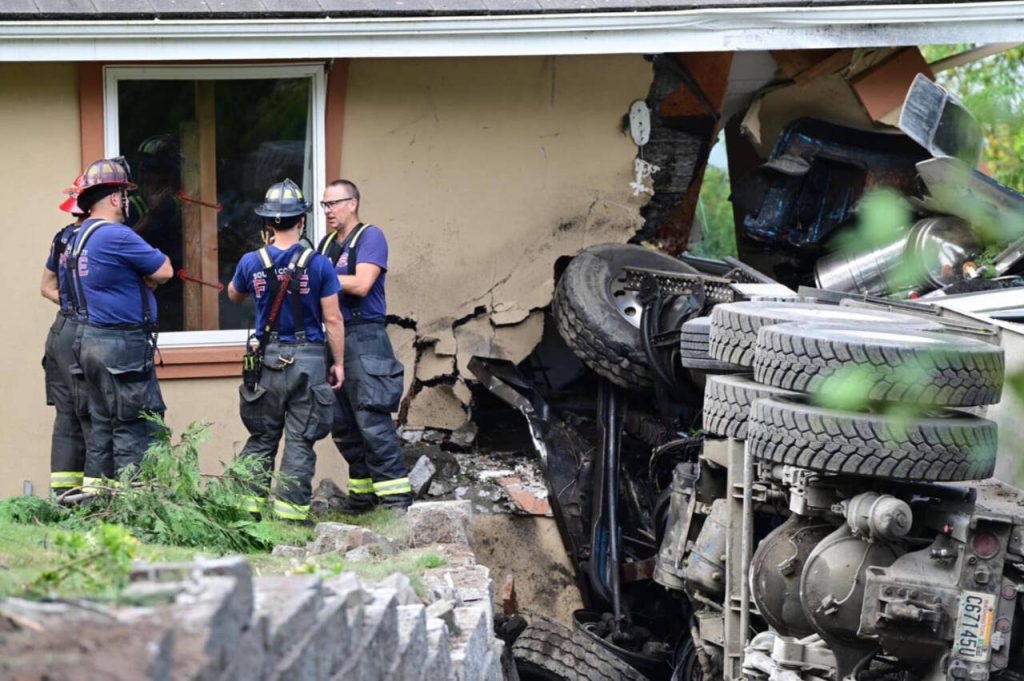 A dump truck crashed into an Edmonds home and knocked out power lines Wednesday morning. (Courtesy of South County Fire)