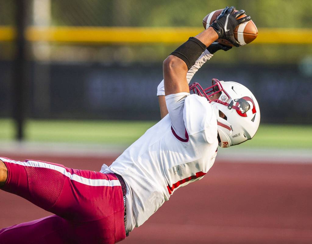 Cascades Marcell Alexander makes a diving catch in the end zone for a touchdown during the game against Mountlake Terrace on Friday, Sept. 6, 2024 in Edmonds, Washington. (Olivia Vanni / The Herald)