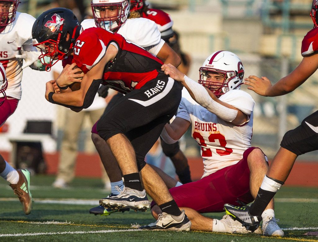 Cascades Gavin Chapman tries to hang on to Mountlake Terraces Owen Boswell as he runs the ball during the game on Friday, Sept. 6, 2024 in Edmonds, Washington. (Olivia Vanni / The Herald)